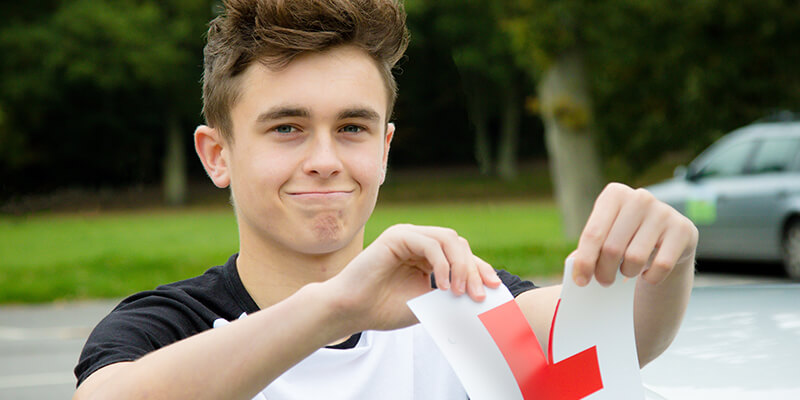 boy ripping learner plate