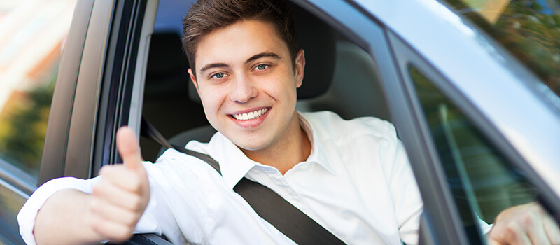 man in car thumbs up