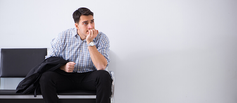 nervous man sitting in waiting room